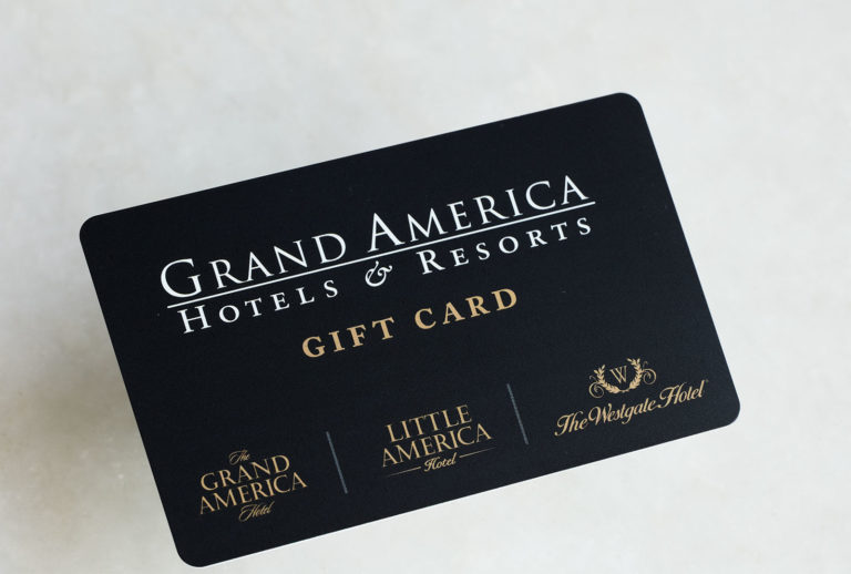 Black and gold Grand America Hotels and Resorts gift card on white marble