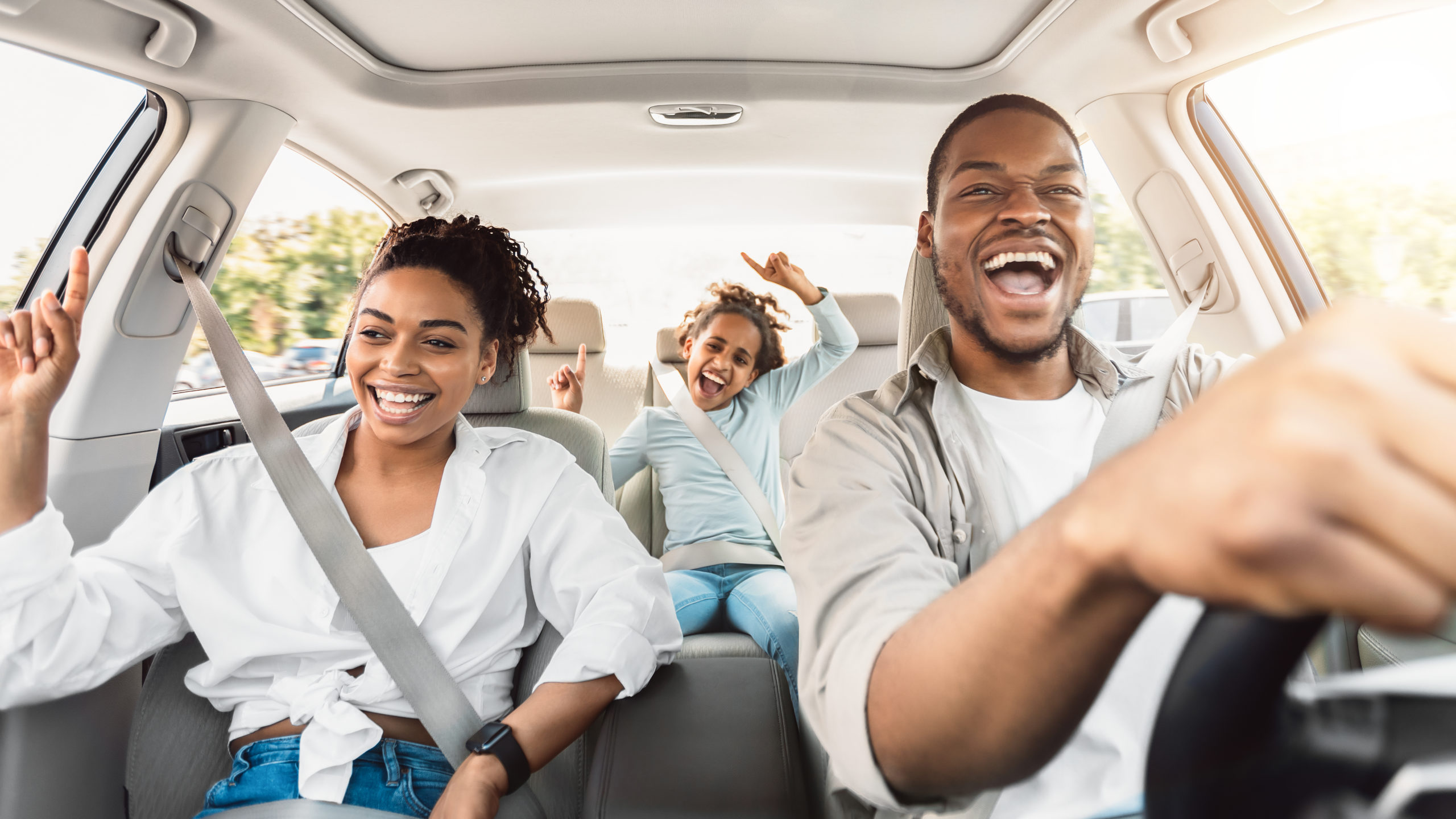 Happy family of three having fun on a road trip